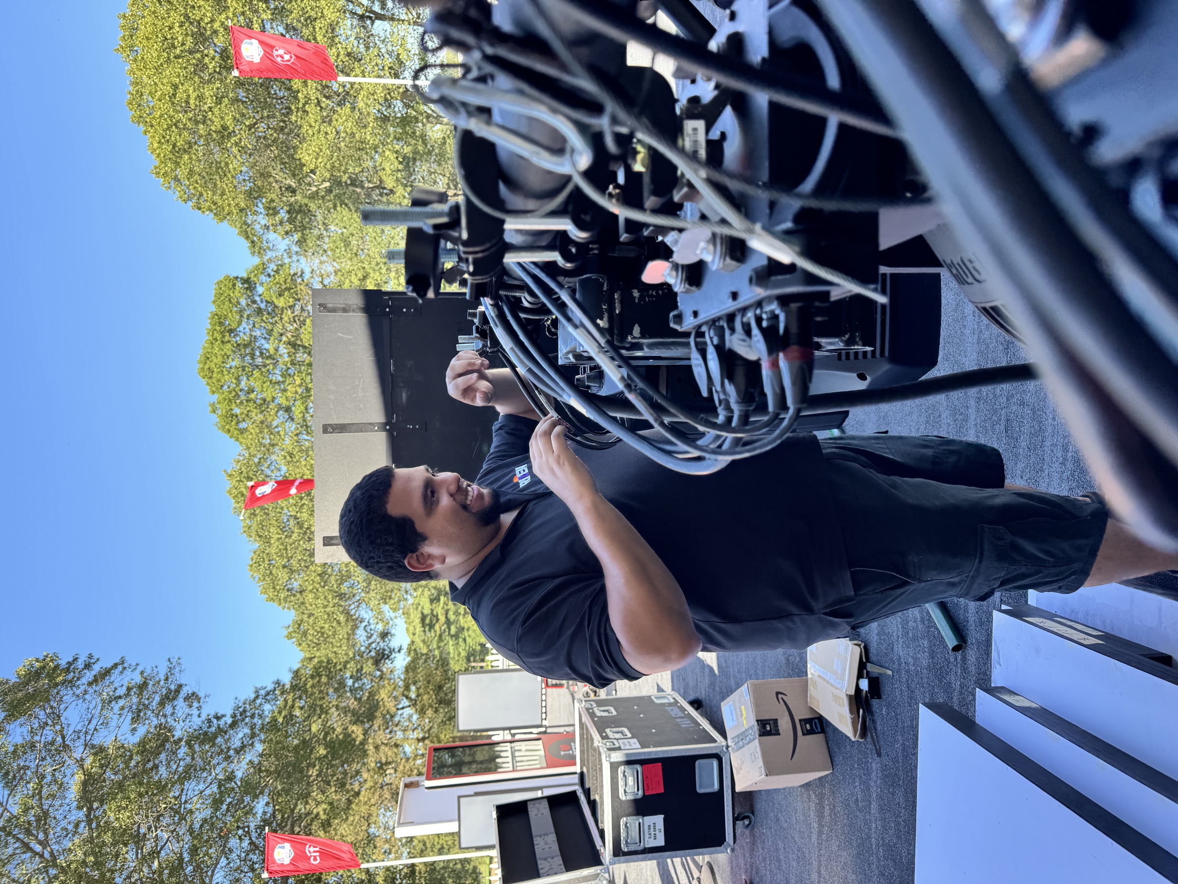 A Rizen lighting technician preparing fixtures and cabling during load-in